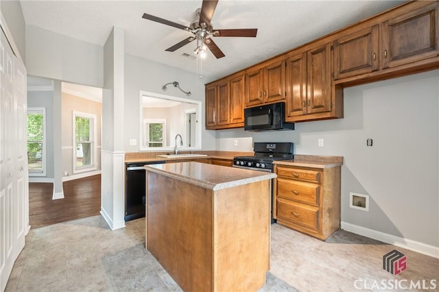 kitchen with a center island, a sink, dishwashing machine, black microwave, and gas range oven