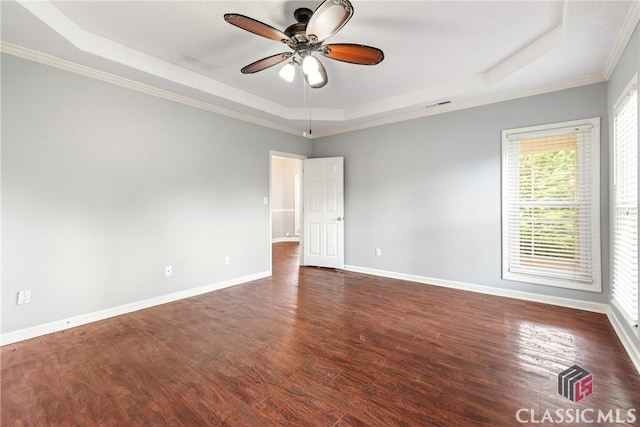 spare room featuring crown molding, a tray ceiling, ceiling fan, and visible vents