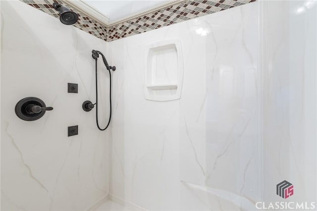 bathroom with a marble finish shower