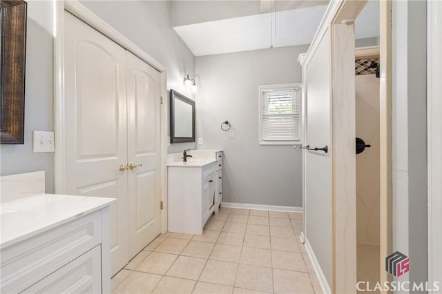 bathroom featuring tile patterned floors, vanity, and baseboards