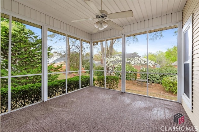 unfurnished sunroom with ceiling fan