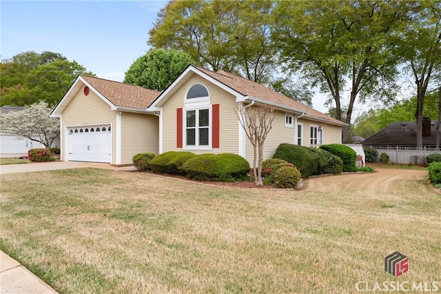 single story home with driveway, a garage, and a front lawn