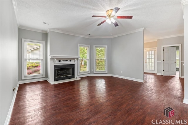 unfurnished living room with a wealth of natural light, a ceiling fan, and wood finished floors