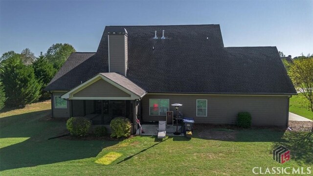 1296 Club Estates Rd, Statham, GA 30666 - back of property with a sunroom, a chimney, and a lawn
