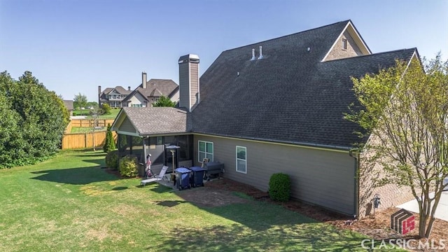 1296 Club Estates Rd, Statham, GA 30666 - rear view of house with a yard, fence, and a shingled roof
