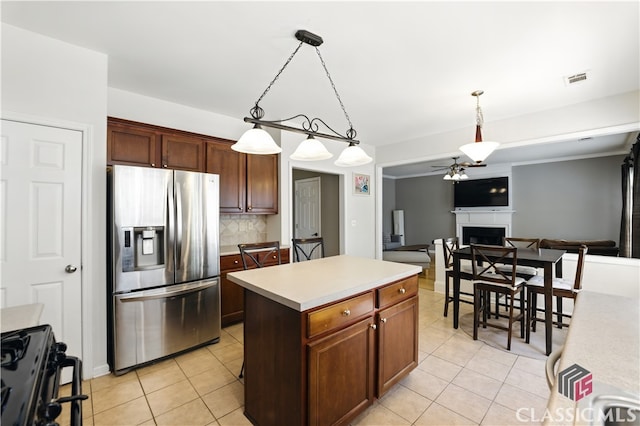 340 Hammersmith Dr, Suwanee, GA 30024 - kitchen featuring stainless steel fridge with ice dispenser, gas range oven, light tile patterned floors, and a fireplace