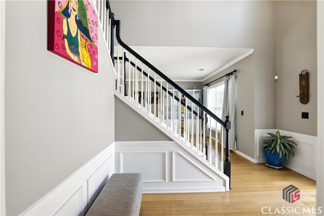 340 Hammersmith Dr, Suwanee, GA 30024 - stairs featuring wood finished floors, wainscoting, ornamental molding, and a decorative wall