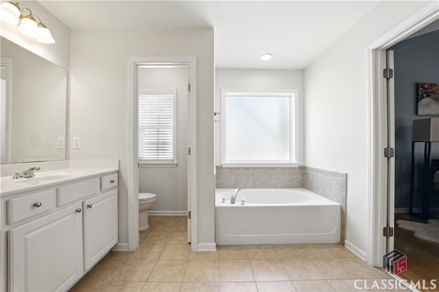340 Hammersmith Dr, Suwanee, GA 30024 - bathroom featuring vanity, a bath, toilet, tile patterned floors, and baseboards