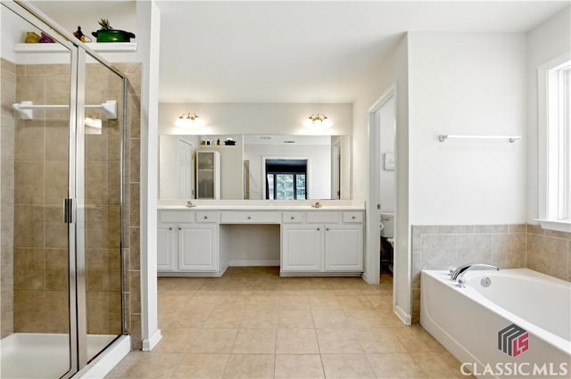 340 Hammersmith Dr, Suwanee, GA 30024 - full bath featuring double vanity, a stall shower, healthy amount of natural light, and a garden tub