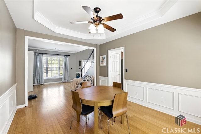 340 Hammersmith Dr, Suwanee, GA 30024 - dining area with a tray ceiling, ceiling fan, a wainscoted wall, stairs, and ornamental molding