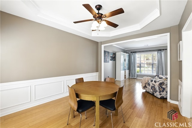 340 Hammersmith Dr, Suwanee, GA 30024 - dining space with a tray ceiling, crown molding, light wood-style flooring, a ceiling fan, and wainscoting
