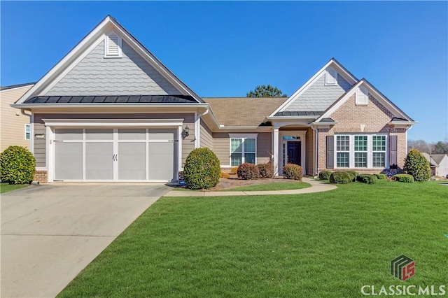 6706 Mill Rock Ct, Hoschton, GA 30548 - view of front of home featuring concrete driveway, a garage, brick siding, a standing seam roof, and metal roof