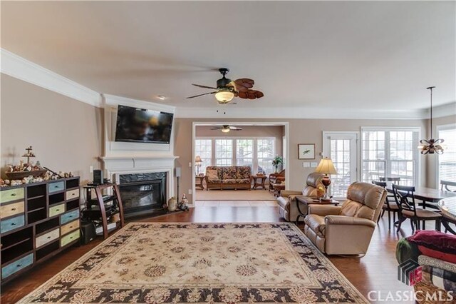 6706 Mill Rock Ct, Hoschton, GA 30548 - living room featuring visible vents, ceiling fan, a premium fireplace, and wood finished floors