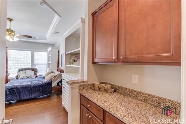 6706 Mill Rock Ct, Hoschton, GA 30548 - bedroom featuring crown molding, a tray ceiling, ensuite bath, wood finished floors, and baseboards