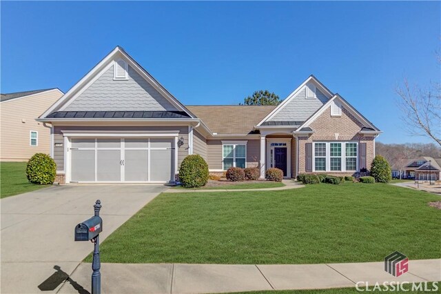 6706 Mill Rock Ct, Hoschton, GA 30548 - craftsman-style home with a standing seam roof, brick siding, concrete driveway, and metal roof