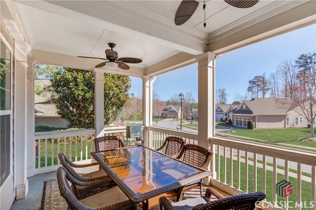 6706 Mill Rock Ct, Hoschton, GA 30548 - entrance foyer with crown molding, ceiling fan, a fireplace, dark wood finished floors, and ornate columns