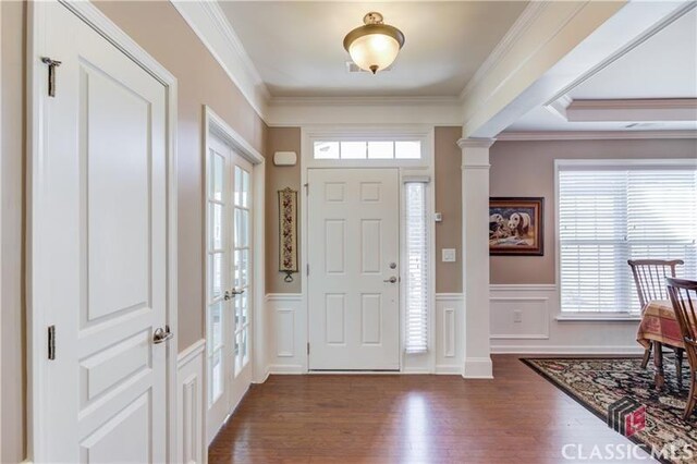6706 Mill Rock Ct, Hoschton, GA 30548 - dining space featuring a chandelier, a raised ceiling, wood finished floors, and ornamental molding