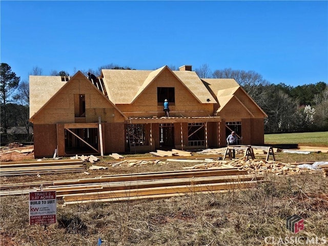 view of front of house featuring a chimney