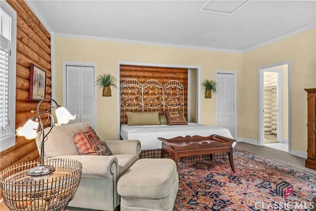 bedroom featuring attic access, baseboards, crown molding, and carpet floors