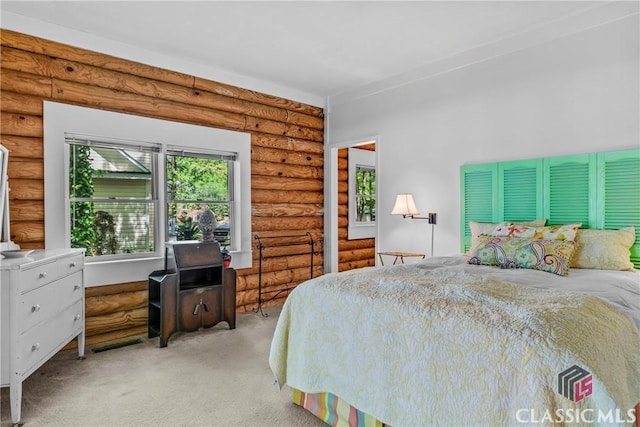bedroom featuring rustic walls and light colored carpet