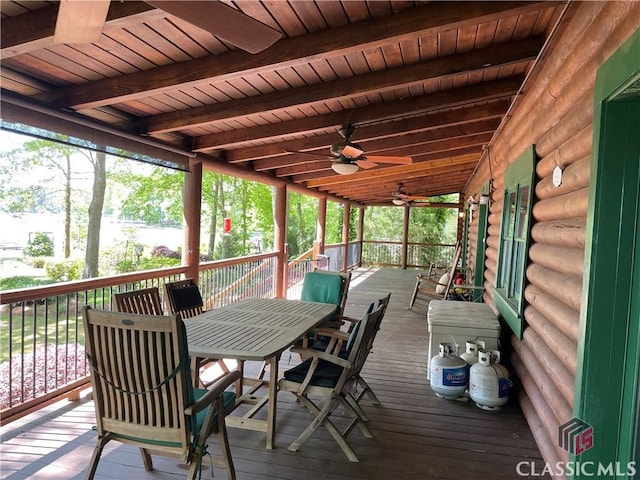 wooden terrace featuring outdoor dining area