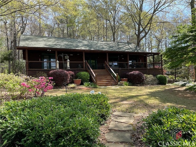 view of front of property featuring stairway and a porch