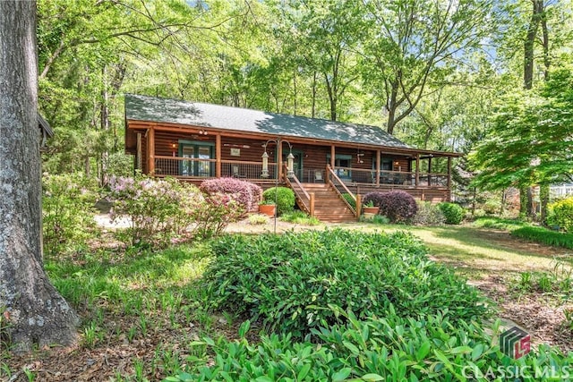 view of front of property with a porch and log siding