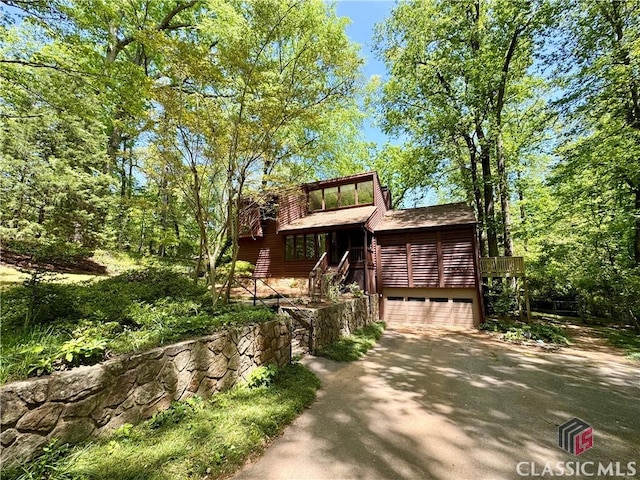 exterior space featuring driveway and stairs