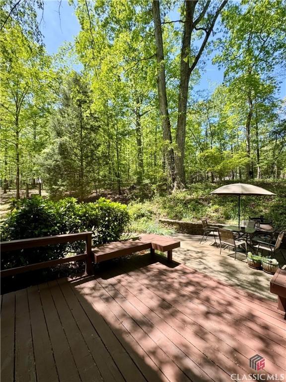 wooden deck featuring outdoor dining area