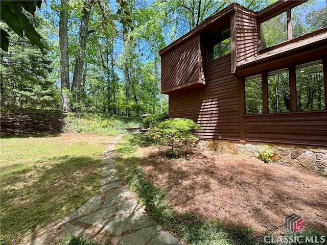 view of home's exterior with a yard