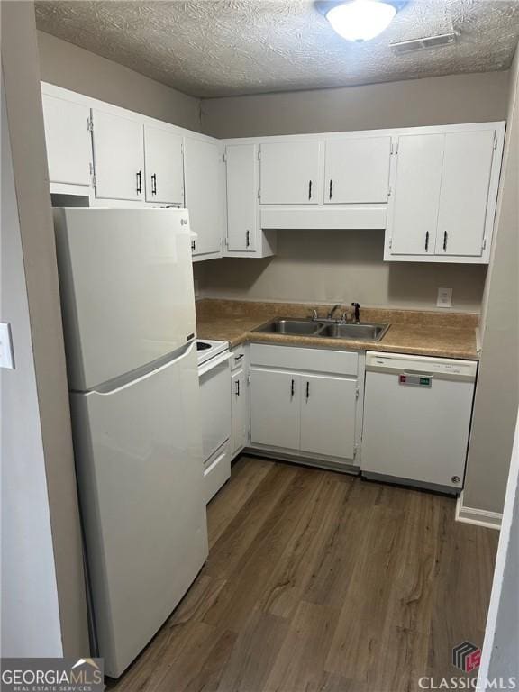 435 Rustwood Dr, Athens, GA 30606 - kitchen featuring white cabinets, dark wood-style flooring, a sink, and white appliances