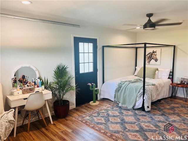 bedroom with baseboards, wood finished floors, a ceiling fan, and recessed lighting
