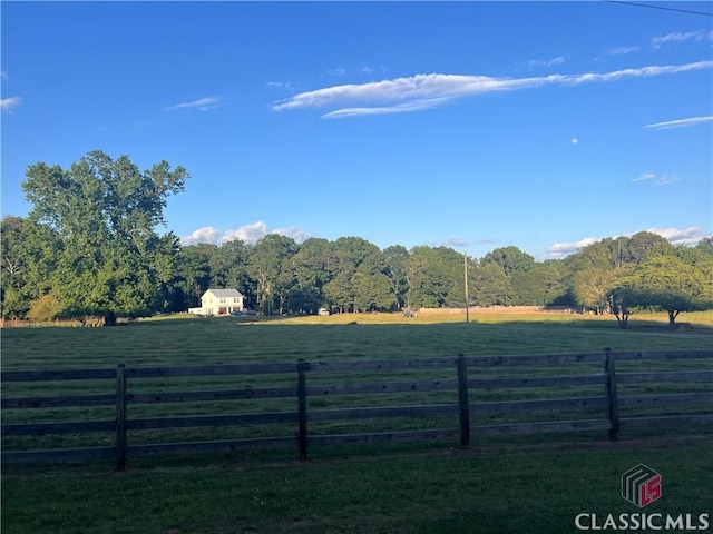 view of yard featuring a rural view and fence