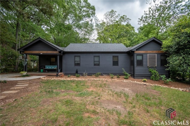 ranch-style home featuring an attached carport