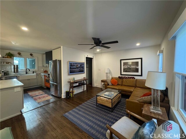 living area featuring ceiling fan, recessed lighting, and dark wood finished floors