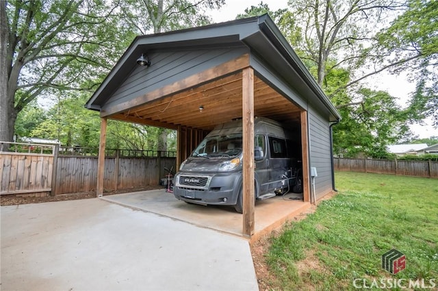 view of car parking with concrete driveway, a carport, and fence