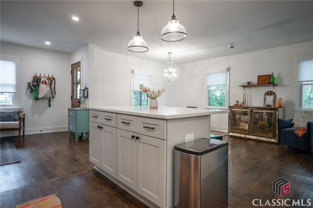 kitchen with dark wood-type flooring, light countertops, and plenty of natural light