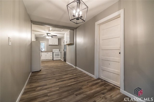 451 N Woodlawn Dr, Crawford, GA 30630 - corridor with dark wood finished floors, baseboards, and an inviting chandelier
