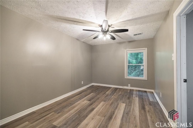 451 N Woodlawn Dr, Crawford, GA 30630 - unfurnished room with wood finished floors, visible vents, baseboards, a textured ceiling, and ceiling fan