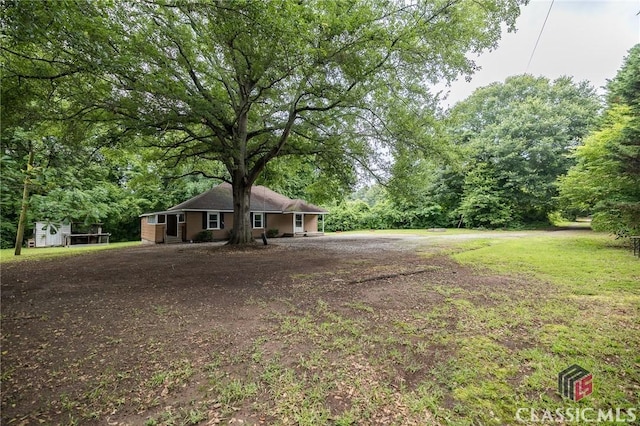 451 N Woodlawn Dr, Crawford, GA 30630 - ranch-style house with an outbuilding and a storage shed