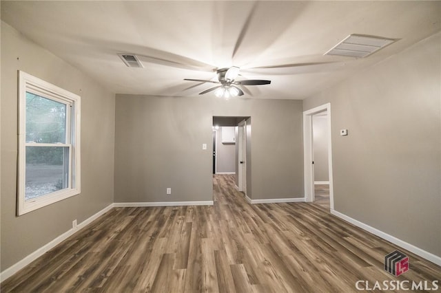 451 N Woodlawn Dr, Crawford, GA 30630 - spare room with baseboards, visible vents, dark wood-type flooring, and ceiling fan