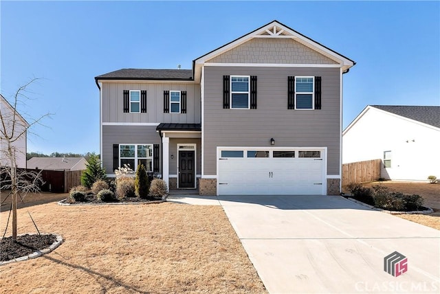 craftsman house featuring concrete driveway, stone siding, board and batten siding, an attached garage, and fence