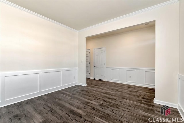 unfurnished room with dark wood-type flooring, a decorative wall, and ornamental molding