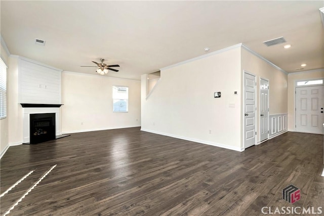 unfurnished living room with visible vents, dark wood-type flooring, ceiling fan, and crown molding