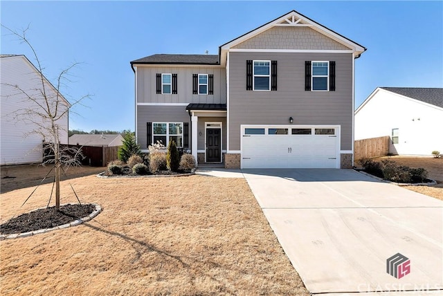 view of front of property featuring a garage, fence, stone siding, and concrete driveway