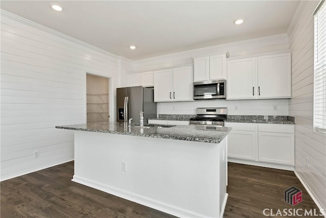 kitchen with white cabinets, a sink, a kitchen island with sink, appliances with stainless steel finishes, and dark wood-style flooring