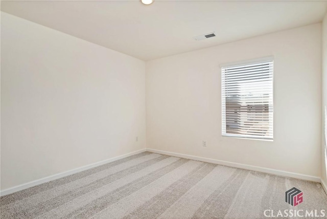 unfurnished room featuring light colored carpet, baseboards, and visible vents