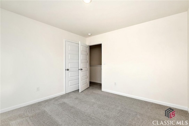 unfurnished bedroom with baseboards and carpet flooring