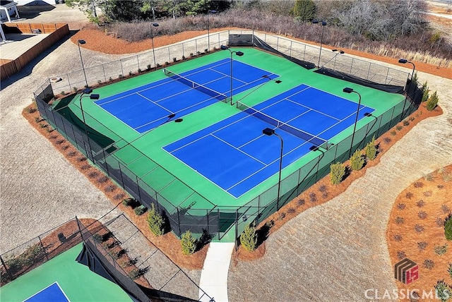 view of tennis court featuring fence