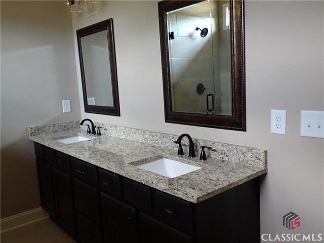 41 Hometown Ct, Jefferson, GA 30549 - full bath featuring a sink, a shower stall, and double vanity